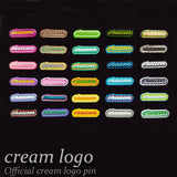 cream logo pin